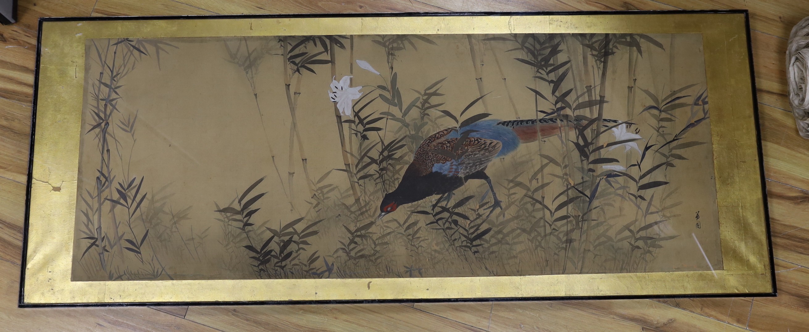 Japanese School, watercolour on silk, Pheasant amongst bamboo and lilies, signed, 50 x 131cm